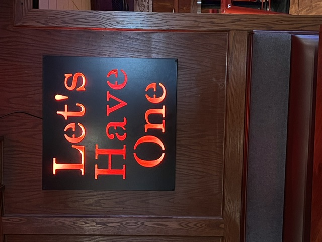 Let's Have One — illuminated sign inside La Playette Bar
